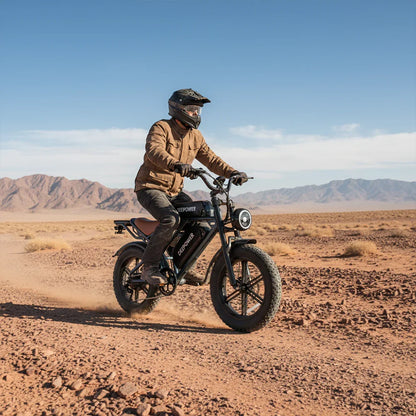 Man wearing helmet riding black DEEPOWER electric bike on rocky desert trail with mountains