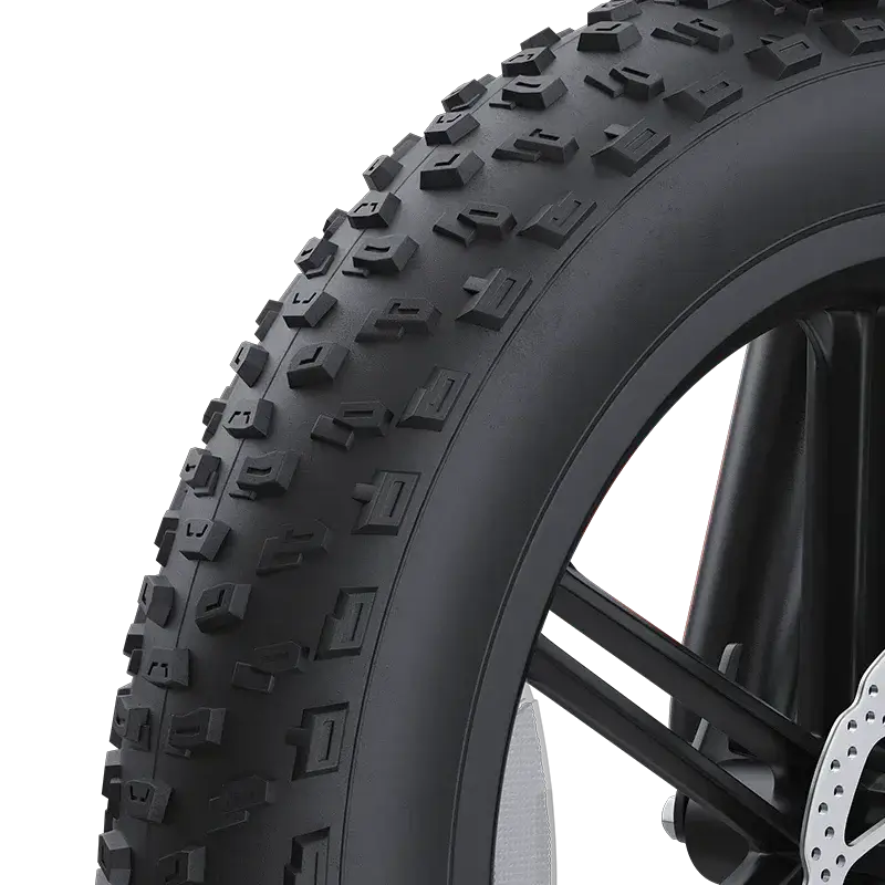 Close-up of 20-inch wide knobby tire for mountain bike with black spokes and disc brake